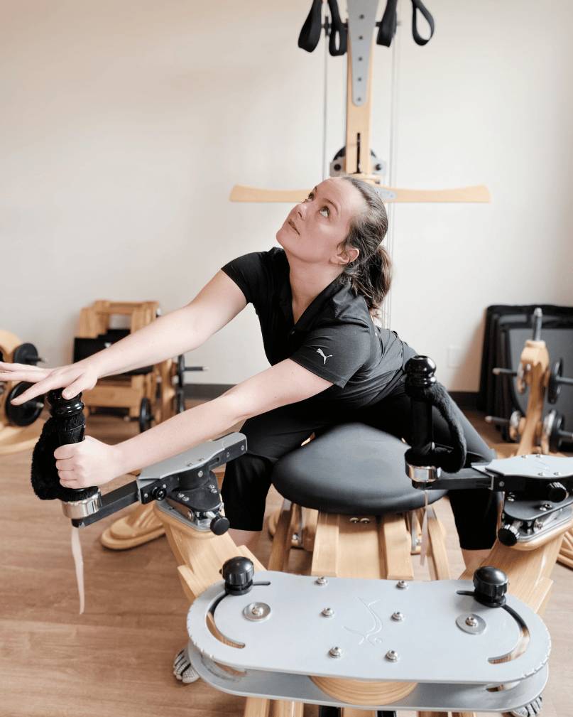 a woman using a stretching machine