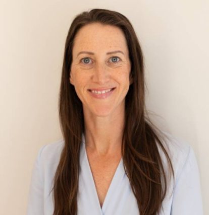 Smiling woman in white shirt